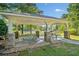 Community pavilion featuring stone pillars, picnic tables, and scenic views of the pond and surrounding greenery at 137 Hidden Lake Cir, Canton, GA 30114
