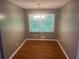 Cozy dining area with hardwood floors and a chandelier, illuminated by a large window at 273 Fennel Way, Atlanta, GA 30331