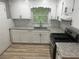 Modern kitchen featuring granite countertops, subway tile backsplash, and stainless steel gas range at 273 Fennel Way, Atlanta, GA 30331