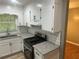 Modern kitchen featuring granite countertops, subway tile backsplash, and stainless steel appliances at 273 Fennel Way, Atlanta, GA 30331