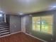 Open-concept living room with hardwood floors and access to a staircase, featuring a large window at 273 Fennel Way, Atlanta, GA 30331