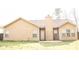 View of the backyard with tan siding and a small patio area at 1109 Norsworthy Ml, Hampton, GA 30228