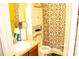Well-maintained bathroom featuring a neutral color scheme, a storage cabinet, and a shower with patterned curtains at 1109 Norsworthy Ml, Hampton, GA 30228