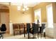 Elegant dining room features a stylish chandelier, comfortable seating, and ample natural light for gatherings at 1109 Norsworthy Ml, Hampton, GA 30228