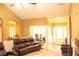 Comfortable living room with arched doorways, plush seating, and a seamless flow to the adjacent dining area at 1109 Norsworthy Ml, Hampton, GA 30228