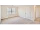 Well-lit bedroom featuring neutral walls, carpet, a window, and a closet door at 1936 Waycross Ln, Dacula, GA 30019
