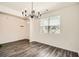 Dining room featuring modern lighting, large window, and hardwood flooring at 1936 Waycross Ln, Dacula, GA 30019