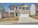 Charming two-story brick home with a two-car garage and well-maintained front lawn at 1936 Waycross Ln, Dacula, GA 30019