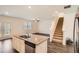 Modern kitchen island, stainless steel appliances, hardwood floor and staircase in a new construction home at 1936 Waycross Ln, Dacula, GA 30019
