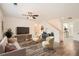 Bright living room features stylish furniture, a ceiling fan, and hardwood floors at 1936 Waycross Ln, Dacula, GA 30019
