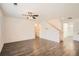 Open living room with hardwood floors, ceiling fan, and ample space for entertaining at 1936 Waycross Ln, Dacula, GA 30019