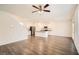 Open-concept space with hardwood floors, kitchen island, and stainless steel appliances at 1936 Waycross Ln, Dacula, GA 30019