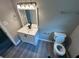 Bathroom with a modern vanity, toilet, gray walls, and laminate flooring at 3730 Clovis Court Northwest Nw Ct, Atlanta, GA 30331