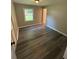 Bedroom featuring gray hardwood flooring, a window letting in natural light and closet at 3730 Clovis Court Northwest Nw Ct, Atlanta, GA 30331
