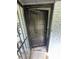 Inviting front door with a black finish, set against a backdrop of brick and wrought iron details at 3730 Clovis Court Northwest Nw Ct, Atlanta, GA 30331