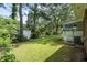 A spacious backyard with grass, trees, and a shed at 999 Chestnut Oak Ct, Lawrenceville, GA 30046
