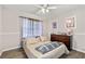 Cozy bedroom with a dark wood dresser and a queen bed at 999 Chestnut Oak Ct, Lawrenceville, GA 30046