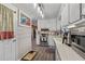Open kitchen with stainless steel appliances, white cabinets, and modern flooring at 999 Chestnut Oak Ct, Lawrenceville, GA 30046