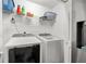 Bright laundry room with modern appliances and ample shelving for storage at 999 Chestnut Oak Ct, Lawrenceville, GA 30046