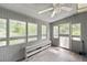 Enclosed sunroom featuring natural light, ceiling fan, and simple gray decor at 999 Chestnut Oak Ct, Lawrenceville, GA 30046