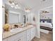Bright bathroom with double sinks, granite countertops, and view to bedroom at 20 Tarpley Way, Covington, GA 30016