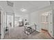 Versatile loft space with carpet, desk area, and multiple doorways leading to other rooms at 20 Tarpley Way, Covington, GA 30016