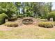 Charming stone neighborhood entrance sign that reads 'Tarpley's Bluff' set amid manicured landscaping at 20 Tarpley Way, Covington, GA 30016