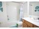 Bright bathroom featuring tub/shower combo and wooden vanity at 6674 Mimosa Cir, Tucker, GA 30084