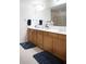 Bathroom featuring double vanity with natural wood cabinets and a large mirror at 6674 Mimosa Cir, Tucker, GA 30084