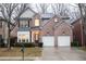 Charming brick home featuring an attached two car garage and well-manicured landscaping at 6674 Mimosa Cir, Tucker, GA 30084