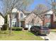 Charming two-story brick home with attached garage, well-maintained lawn, and mature trees in a suburban setting at 6674 Mimosa Cir, Tucker, GA 30084