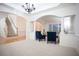 Open-concept living room featuring an arched doorway, staircase, and neutral color palette at 6674 Mimosa Cir, Tucker, GA 30084