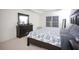 Main bedroom featuring a large bed, dresser, and natural light at 6674 Mimosa Cir, Tucker, GA 30084