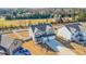 Aerial view showcasing a home with a well-kept lawn, fenced yard, and ample parking at 1049 Bodega Loop, Locust Grove, GA 30248