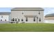 Beautiful backyard space with ample green lawn and a comfortable patio seating area at 1049 Bodega Loop, Locust Grove, GA 30248
