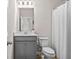 Bathroom with gray vanity, toilet with white shower curtain, and white walls at 1049 Bodega Loop, Locust Grove, GA 30248