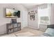 bedroom offers a mounted TV and cubbies near a sunny window at 1049 Bodega Loop, Locust Grove, GA 30248
