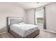 Bedroom featuring a bed, ceiling fan, and a window with light-blocking curtains at 1049 Bodega Loop, Locust Grove, GA 30248