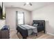 Modern bedroom features a comfortable bed, a ceiling fan, and a bright window at 1049 Bodega Loop, Locust Grove, GA 30248