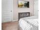 Cozy bedroom featuring a wall-mounted TV and practical storage solutions for an organized space at 1049 Bodega Loop, Locust Grove, GA 30248