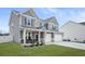 Attractive gray two-story house with manicured lawn, covered porch, and a two-car garage at 1049 Bodega Loop, Locust Grove, GA 30248