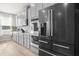 Modern kitchen with gray cabinets and stainless steel appliances, including a black stainless refrigerator at 1049 Bodega Loop, Locust Grove, GA 30248