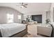 Bright main bedroom with seating area, ceiling fan, and modern sliding door at 1049 Bodega Loop, Locust Grove, GA 30248