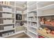 Walk-in pantry featuring white shelves, storage baskets and multiple storage spaces at 1049 Bodega Loop, Locust Grove, GA 30248