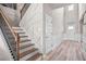 Inviting staircase with wood treads, a dark railing, and decorative wall details at 1049 Bodega Loop, Locust Grove, GA 30248
