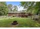 Spacious backyard with a garden area, multiple wood decks, and a cozy firepit at 1051 Rock Springs Rd, Lawrenceville, GA 30043