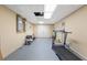 A basement room with neutral-colored walls and a treadmill on the gray floor at 1051 Rock Springs Rd, Lawrenceville, GA 30043