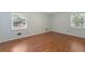 Bedroom with light green walls, wood floor, white trim, and lots of natural light at 1051 Rock Springs Rd, Lawrenceville, GA 30043