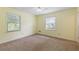 Bright bedroom with neutral carpet, 2 large windows, and yellow painted walls at 1051 Rock Springs Rd, Lawrenceville, GA 30043