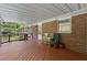 Spacious covered deck with wood floor and railings, and brick exterior at 1051 Rock Springs Rd, Lawrenceville, GA 30043
